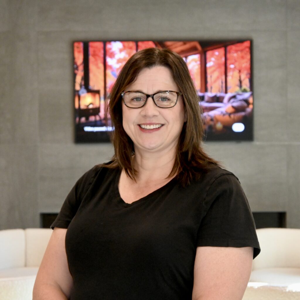 Sarah Allen smiling in the office lobby at NC Implants and Periodontics.